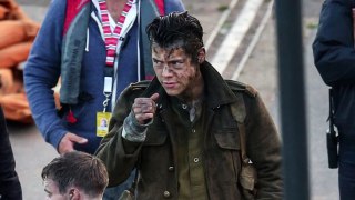 Harry Styles looks wet and muddy as he continues filming scenes for wartime epic Dunkirk