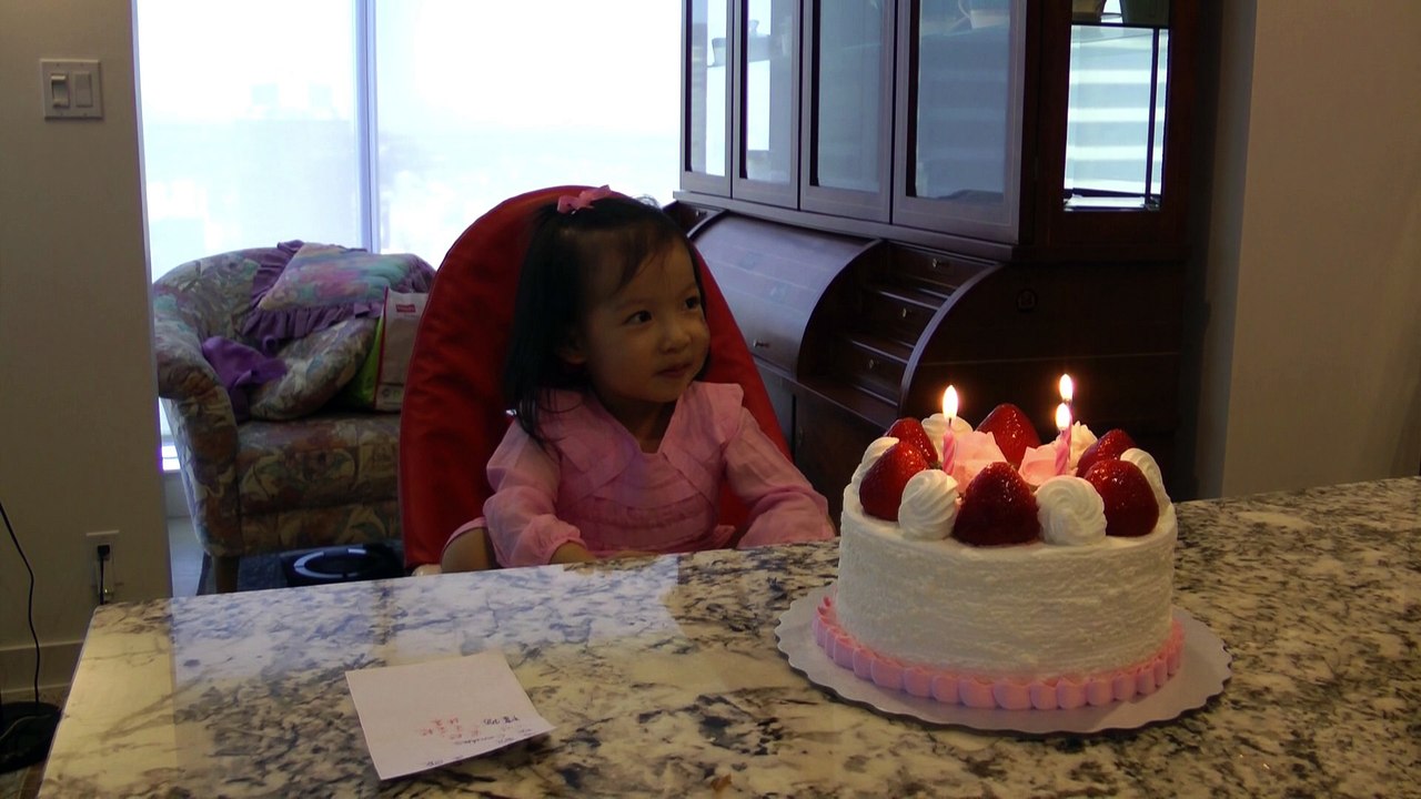Girl Blowing Candles
