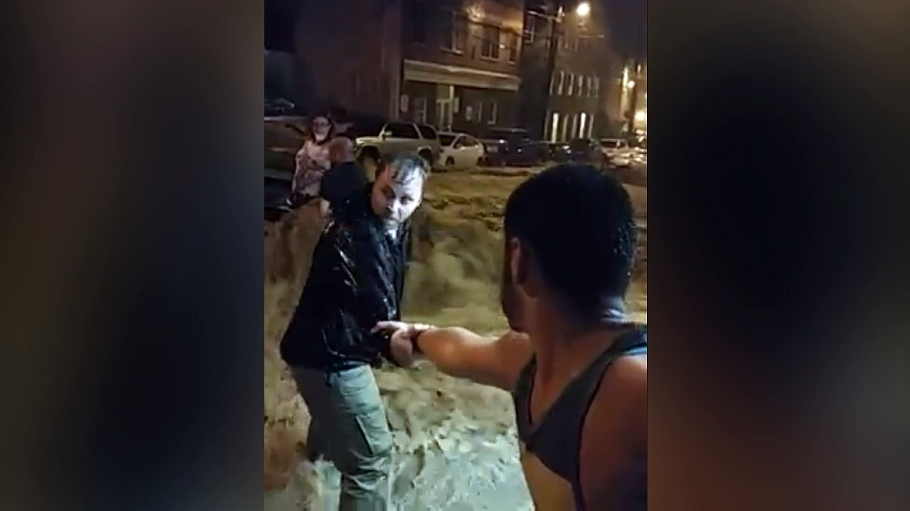 Human chain rescue through flowing flood water in Maryland
