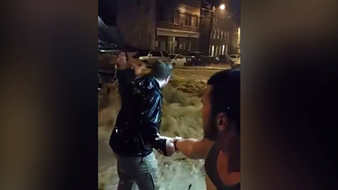 Human chain rescue through flowing flood water in Maryland