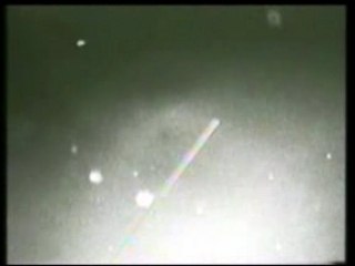 STS-75 Bright Objects Pass Behind