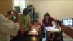 Young Birthday Girl Gets Help Blowing Out Candles