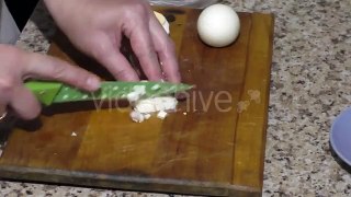 Womans Hands Chopping Eggs For Salad on Board