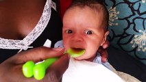 Baby tasting the first time organic tomato juice