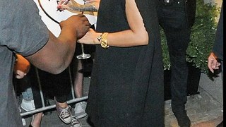 Rihanna looks high spirits clutches glass white wine flaunting legs oversized jumper dress Poland