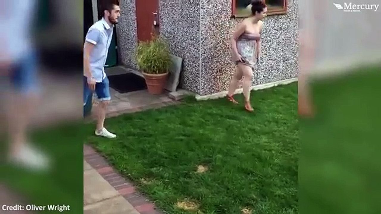 Mother is sent flying after boyfriend slide tackles her during prank