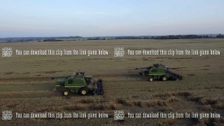 Aerial view combine harvesting a field of wheat.