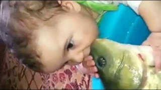 Baby kisses a live fish OMG :O