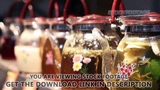 Wide choice of herbal tea drinks in glass teapots standing on cafe counter. Stock Footage
