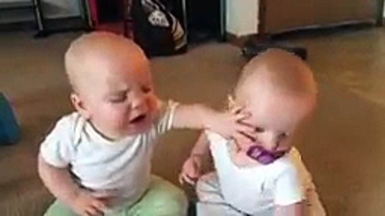 Twin baby girls fight over pacifier