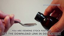 Measuring liquid medicine with a teaspoon, taking cough syrup. Stock Footage