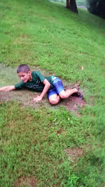 Kids Make Awesome Water Slide In Grass From Typhoon Like Rains & Have Tons of Fun