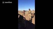 Soldier attempts to catch helmet on his head, fails