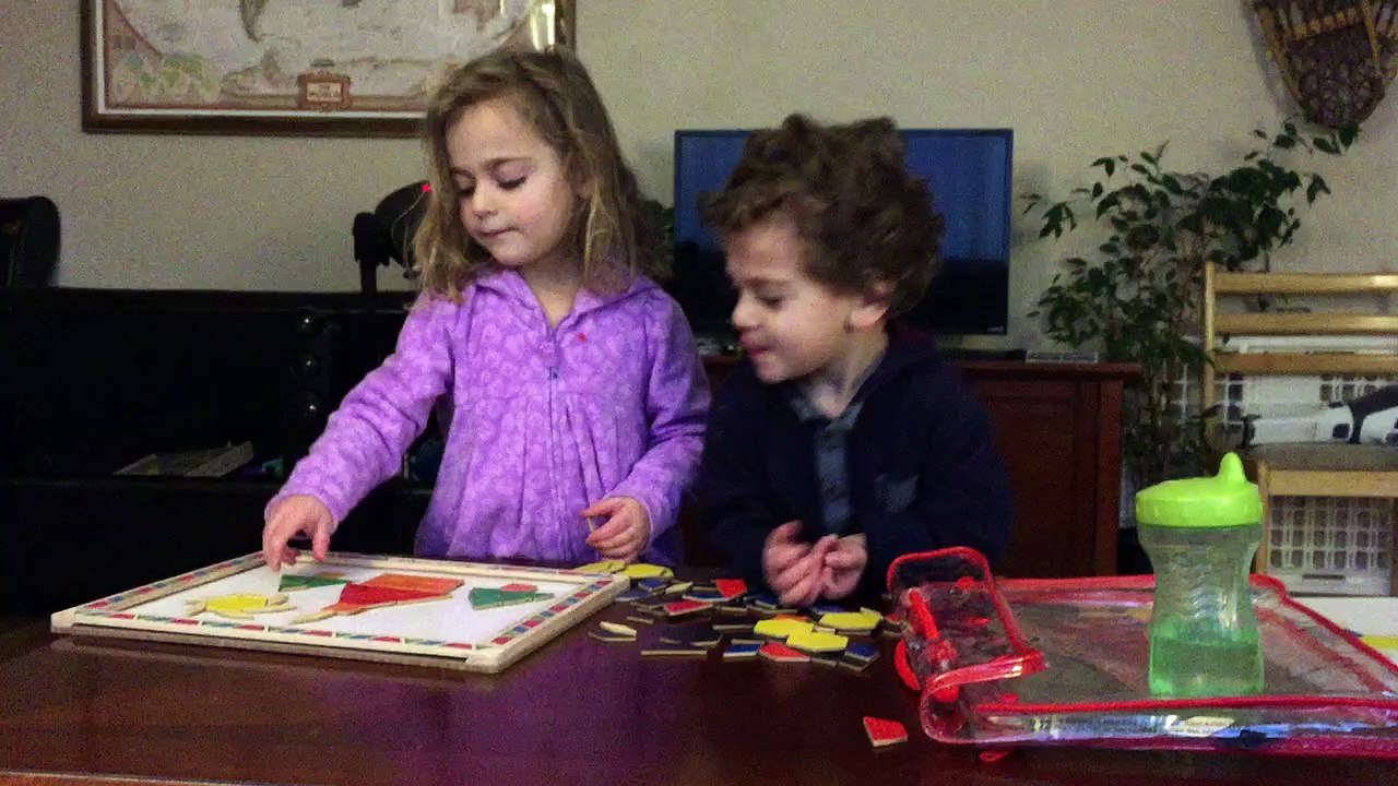 Two Adorable Kids do Puzzle Together