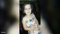 Syrian girl sings happily for the camera