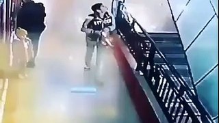 Boy save a girl from falling from stairs in a mall