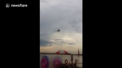 Helicopter crashes into river