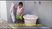 chubby indian baby washing clothes - funny kid kerala india
