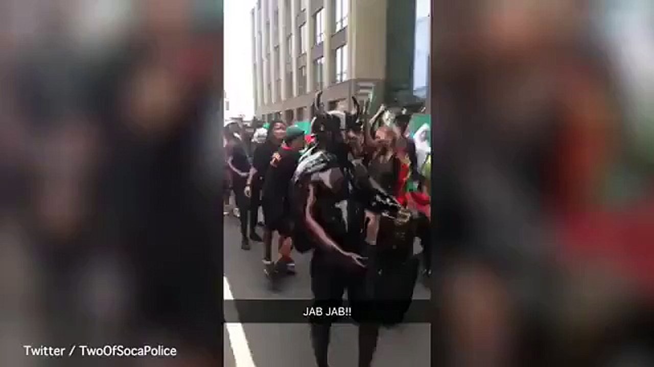 Revellers covered in oil parade through Notting Hill Carnival