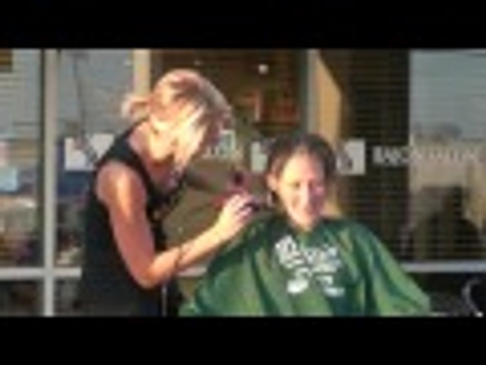 Woman headshave at a St.baldrick's event