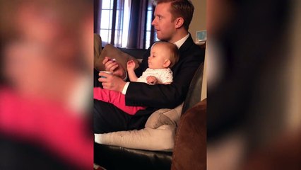 Dad Gets Distracted While Feeding Baby