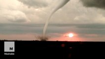 Tornado forms as the sun sets in surprisingly beautiful footage