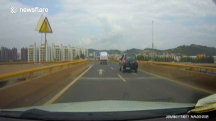 Car narrowly avoids sofa dropped by truck