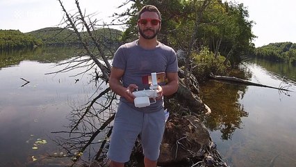 Man uses drone to take a selfie on a beautiful island in a lake