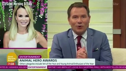 Amanda Holden falls to the floor as large playful dog jumps on her at Animal Hero Awards