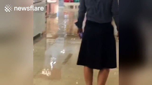 Floodwater pours into luxury department store Harvey Nichols in Manchester
