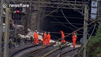 Engineers inspect damage after landslide derails train near Watford Junction