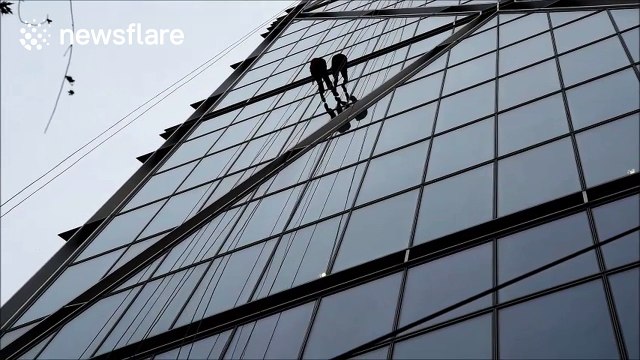 People abseiling down one of the towers in Bishopsgate, London