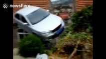Car gets stuck on the roof of a house
