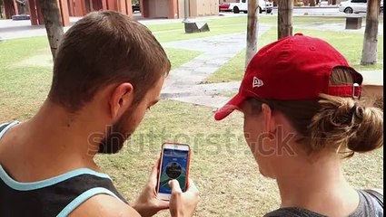 stock-footage-chandler-az-circa-july-two-millennials-play-the-popular-smartphone-game-pokemon-go-in-a