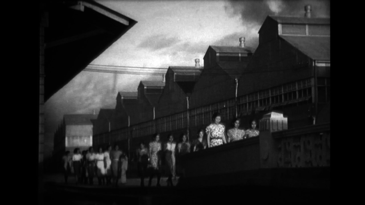 women parading through narrow