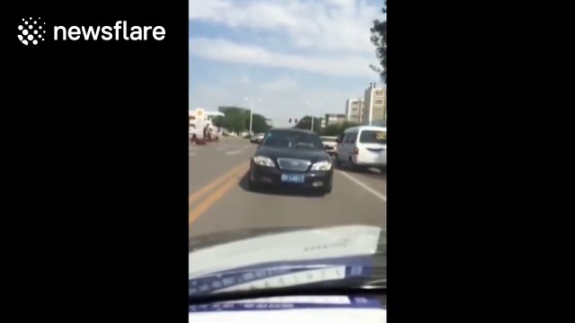 Car drives backwards on road in China