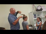 Father Demonstrates How to Tie Daughter's Hair Into a Bun