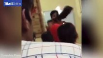 Violent Teacher Caught on Camera Slapping Students and Caning with a Block of Wood