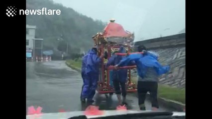 Couples in China press ahead with rainy weddings despite Typhoon Megi