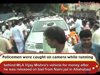 Watch policemen running after MLA's vehicle for money