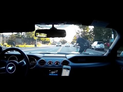 Dramatic Footage Shows Driver Avoiding Swerving Cyclist by Inches