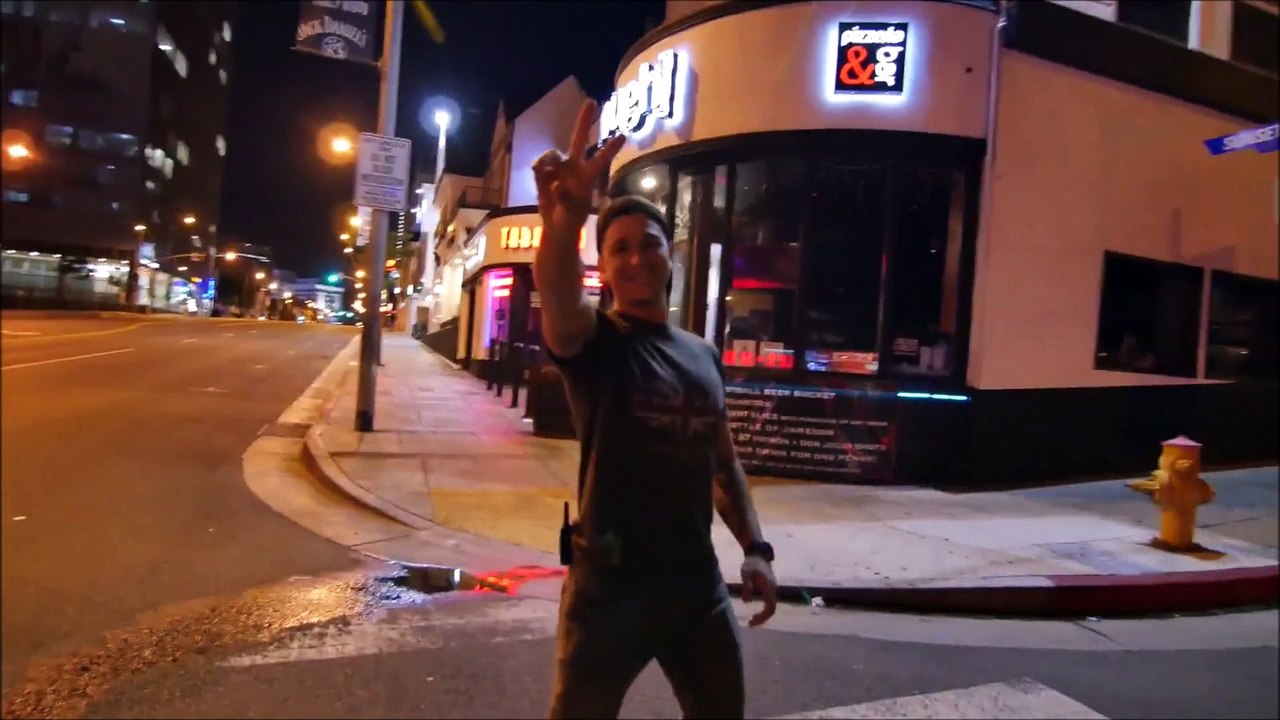 Skaters Glide Down a Deserted Sunset Boulevard