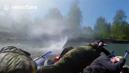 Small waterspout hits rafting boat