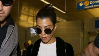 Kourtney Kardashian arrives in LA surrounded by security after sister Kim was held at gunpoint