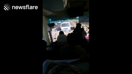 Sheep encircle minibus in China like churning storm cloud