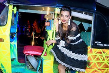 Radhika Apte poses in an auto rickshaw at a promotional event