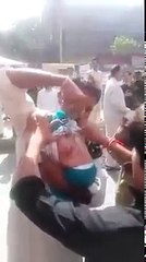 Man beating his child on 10th Muharam