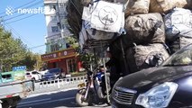This vehicle in China is ridiculously overloaded