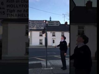 Kid Flips Bottle on Top of a Road Sign