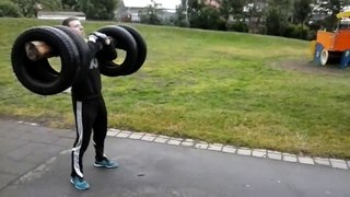 Icelandic Viking Erlingur Guðmundsson Squat farmer walk with log and tires